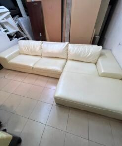 A modern L-shaped white leather sofa featuring a wide armrest and comfortable back cushions. - Image 2