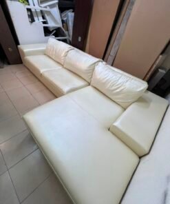 A modern L-shaped white leather sofa featuring a wide armrest and comfortable back cushions. - Image 10