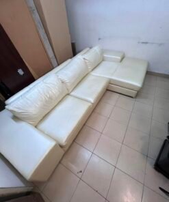 A modern L-shaped white leather sofa featuring a wide armrest and comfortable back cushions. - Image 11