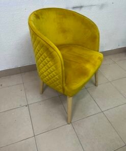 The modern chair features luxurious yellow velvet upholstery, a curved back with a padded design on the sides, and sturdy wooden legs. - Image 2