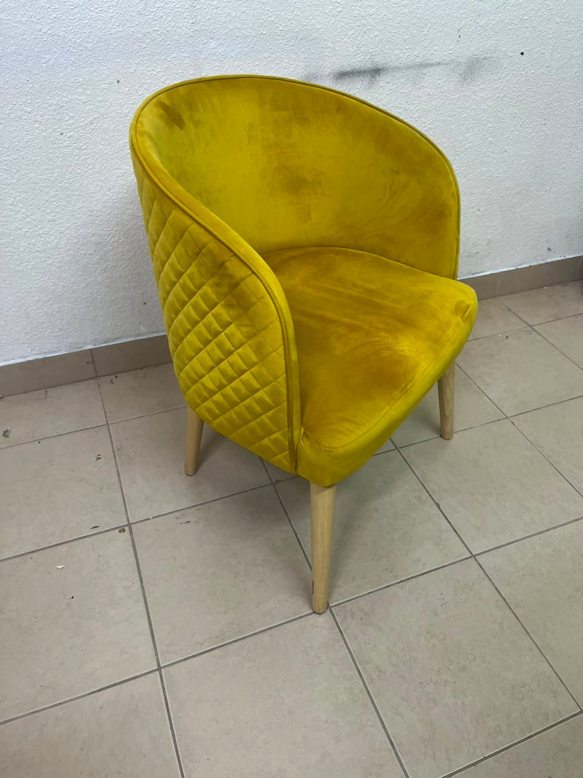 The modern chair features luxurious yellow velvet upholstery, a curved back with a padded design on the sides, and sturdy wooden legs. - Image 2