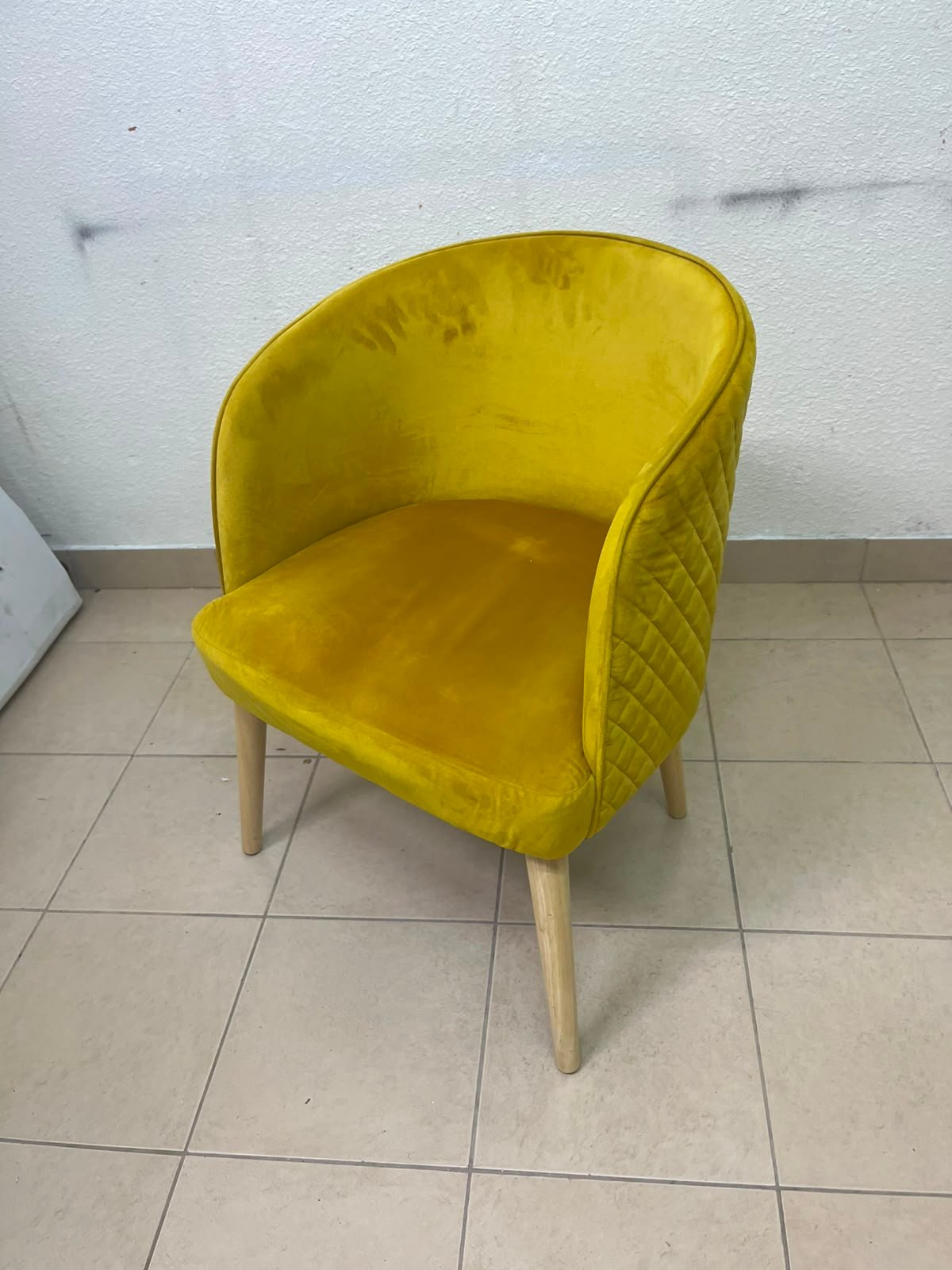 The modern chair features luxurious yellow velvet upholstery, a curved back with a padded design on the sides, and sturdy wooden legs. - Image 5