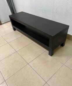 The image shows a TV stand from the IKEA LACK collection in black and brown.