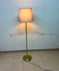 A modern and elegant floor lamp (lampade) with a slim, copper-gold metal base and a warm fabric shade. - Image 8