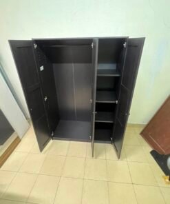The RAKKESTAD wardrobe from IKEA has three doors and comes in a black-brown color, measuring 117x176 cm. - Image 3