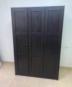 The RAKKESTAD wardrobe from IKEA has three doors and comes in a black-brown color, measuring 117x176 cm. - Image 6