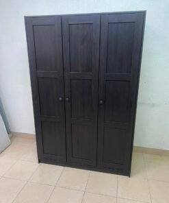 The RAKKESTAD wardrobe from IKEA has three doors and comes in a black-brown color, measuring 117x176 cm. - Image 2