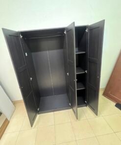 The RAKKESTAD wardrobe from IKEA has three doors and comes in a black-brown color, measuring 117x176 cm. - Image 5
