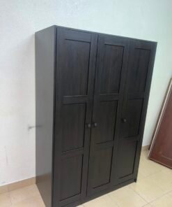The RAKKESTAD wardrobe from IKEA has three doors and comes in a black-brown color, measuring 117x176 cm. - Image 9