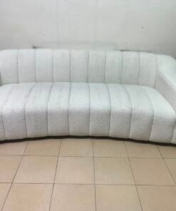 With the cream-colored Eichholtz Kelly Bouclé sofa, which features a distinctive design with signature vertical stitching and soft-touch upholstery. - Image 9