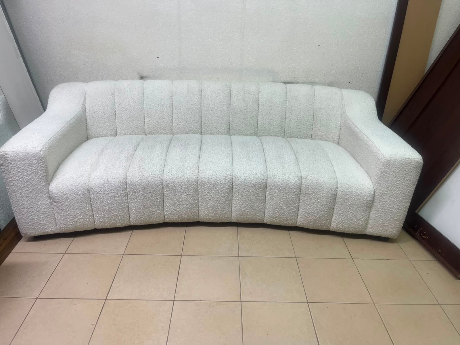 With the cream-colored Eichholtz Kelly Bouclé sofa, which features a distinctive design with signature vertical stitching and soft-touch upholstery. - Image 9