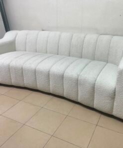 With the cream-colored Eichholtz Kelly Bouclé sofa, which features a distinctive design with signature vertical stitching and soft-touch upholstery. - Image 6