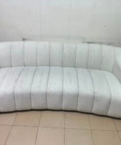 With the cream-colored Eichholtz Kelly Bouclé sofa, which features a distinctive design with signature vertical stitching and soft-touch upholstery. - Image 7