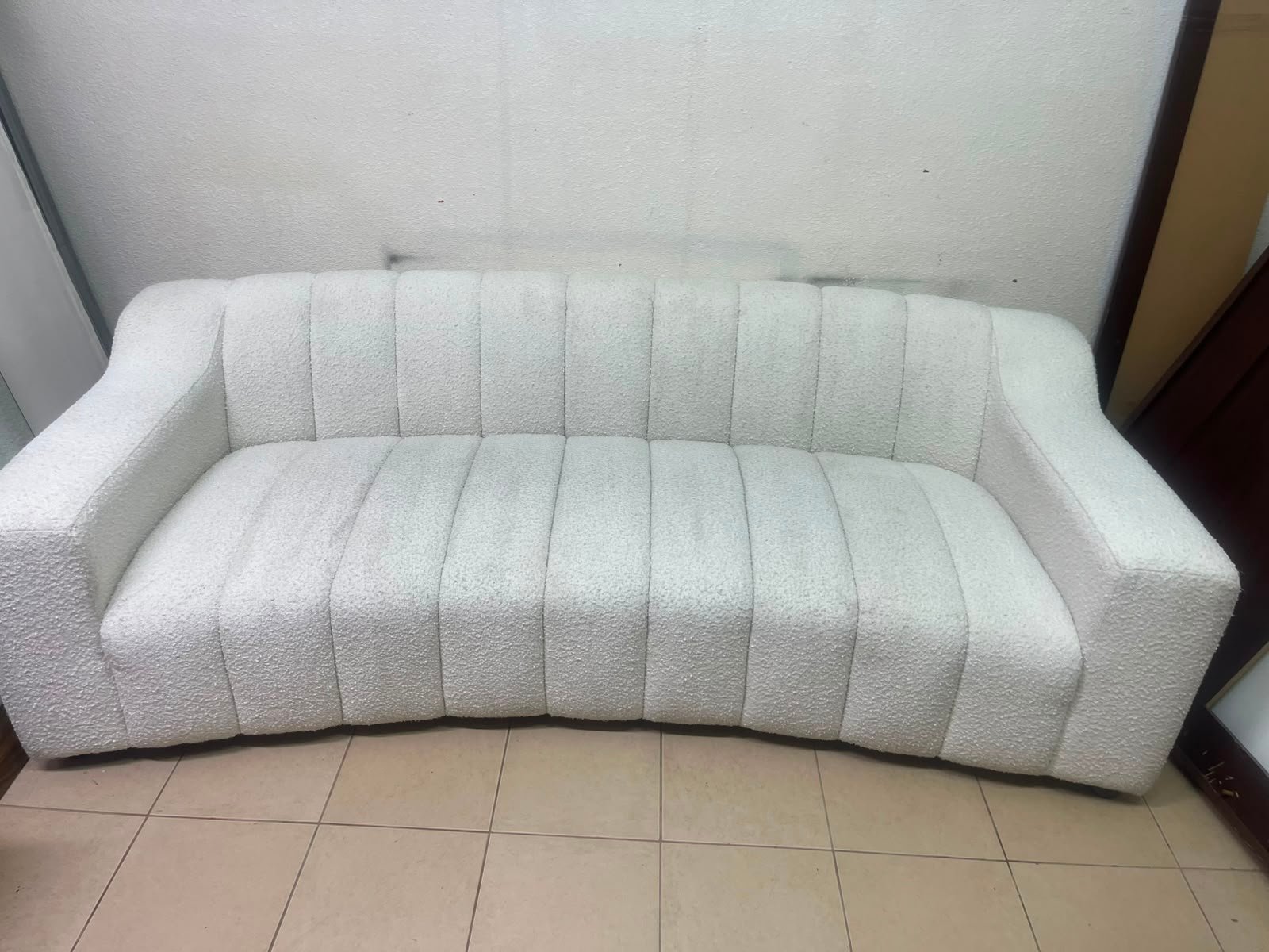 With the cream-colored Eichholtz Kelly Bouclé sofa, which features a distinctive design with signature vertical stitching and soft-touch upholstery. - Image 7