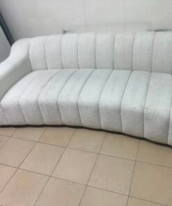 With the cream-colored Eichholtz Kelly Bouclé sofa, which features a distinctive design with signature vertical stitching and soft-touch upholstery. - Image 4