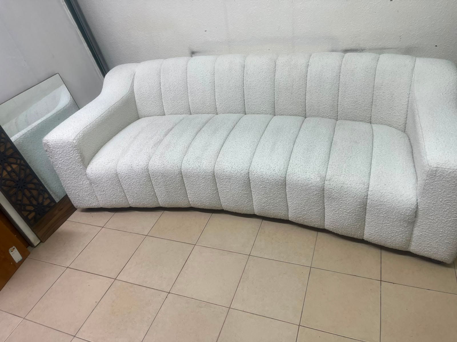 With the cream-colored Eichholtz Kelly Bouclé sofa, which features a distinctive design with signature vertical stitching and soft-touch upholstery. - Image 4