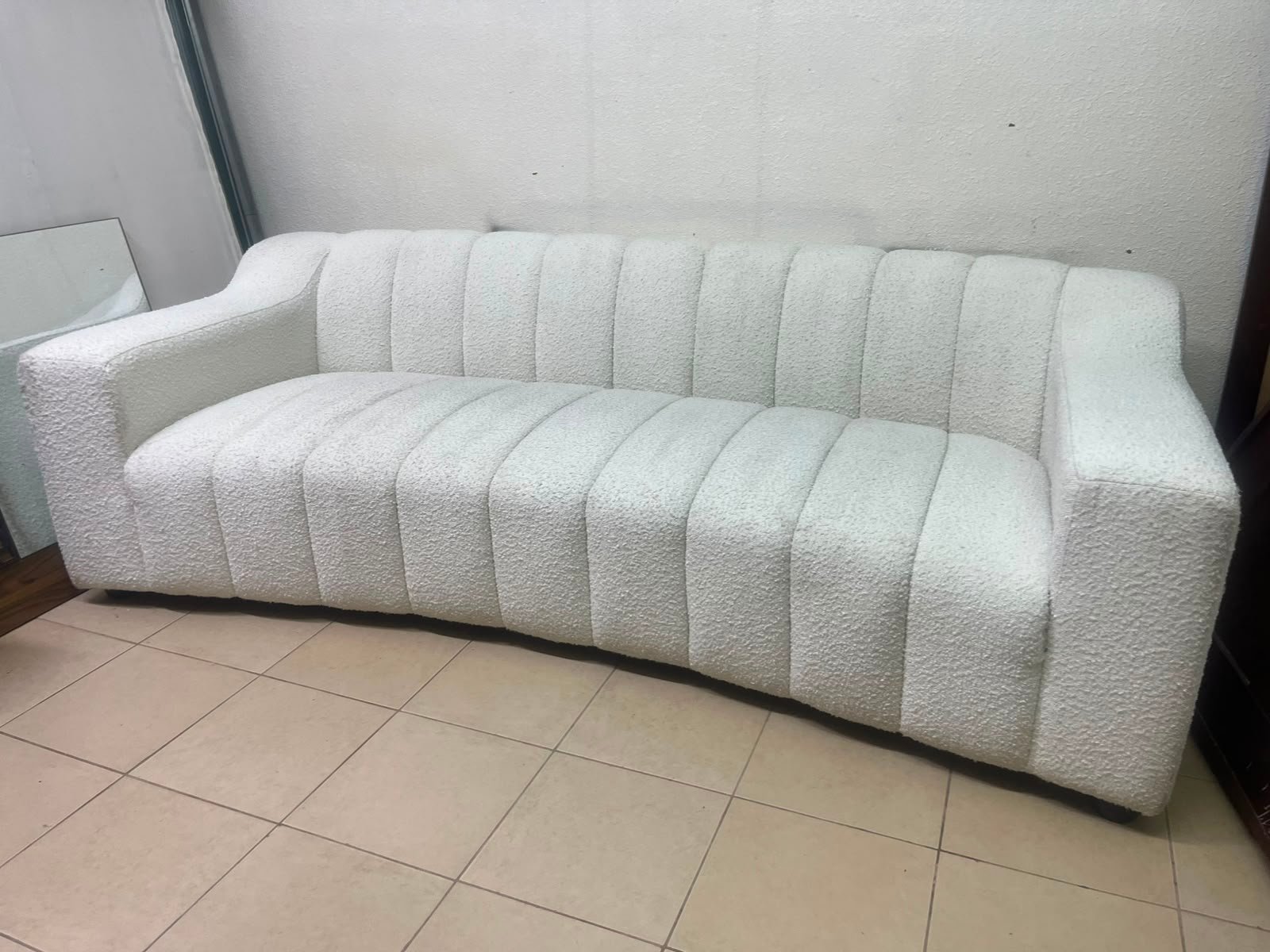 With the cream-colored Eichholtz Kelly Bouclé sofa, which features a distinctive design with signature vertical stitching and soft-touch upholstery. - Image 5