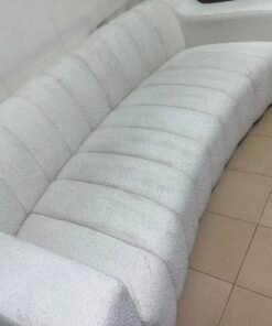 With the cream-colored Eichholtz Kelly Bouclé sofa, which features a distinctive design with signature vertical stitching and soft-touch upholstery. - Image 12