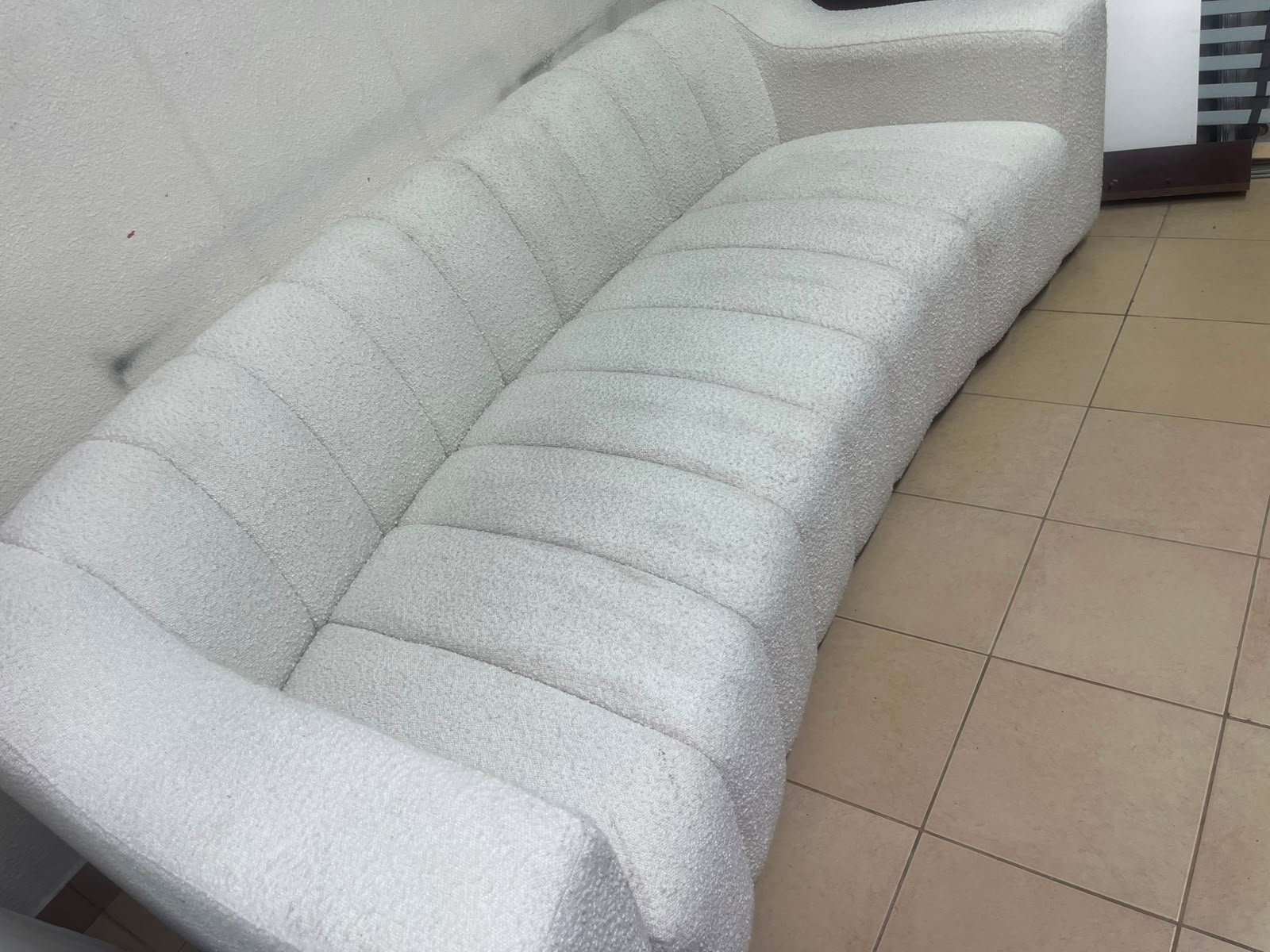 With the cream-colored Eichholtz Kelly Bouclé sofa, which features a distinctive design with signature vertical stitching and soft-touch upholstery. - Image 12