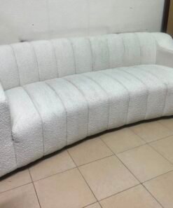 With the cream-colored Eichholtz Kelly Bouclé sofa, which features a distinctive design with signature vertical stitching and soft-touch upholstery. - Image 3