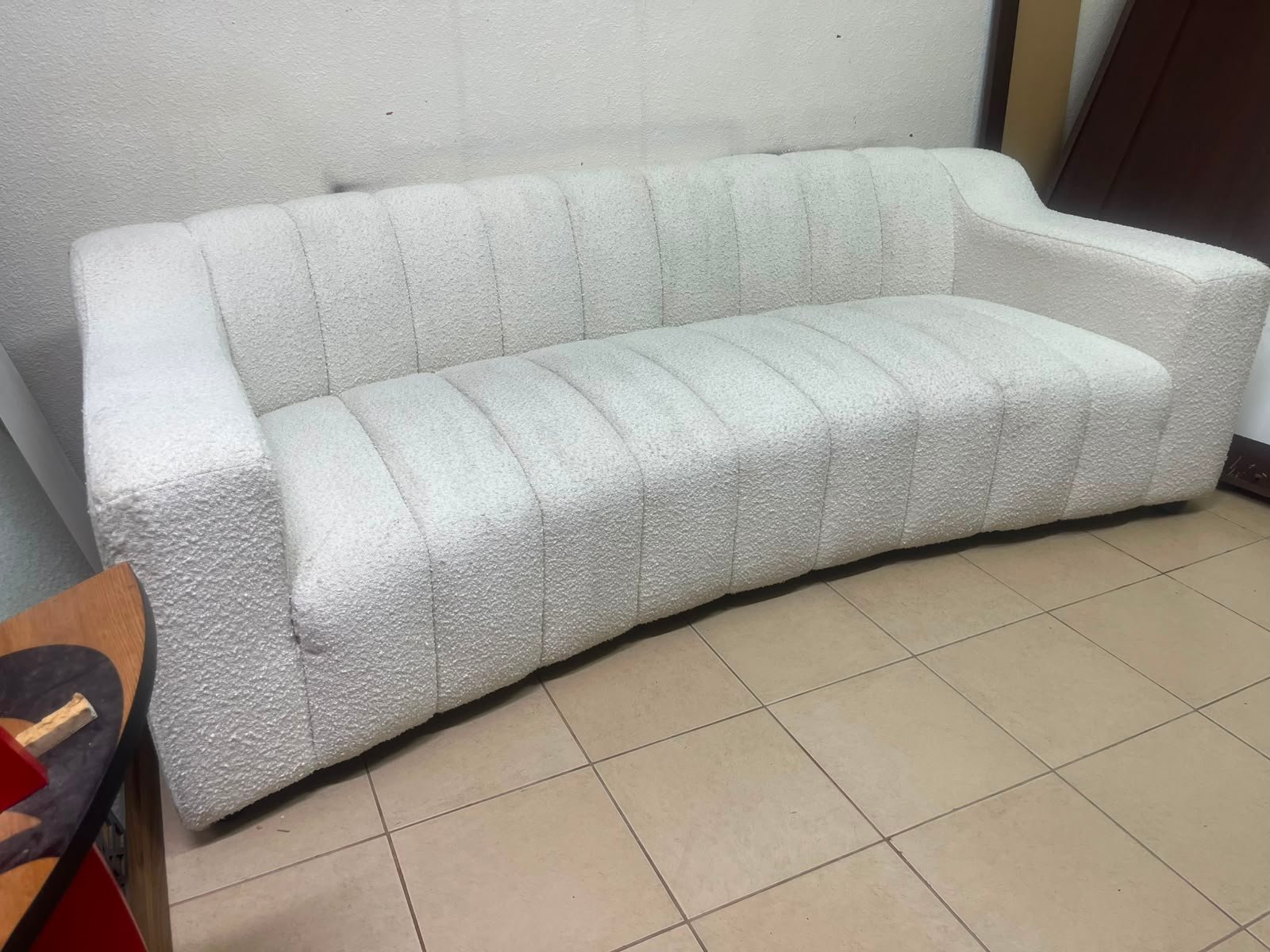 With the cream-colored Eichholtz Kelly Bouclé sofa, which features a distinctive design with signature vertical stitching and soft-touch upholstery. - Image 3