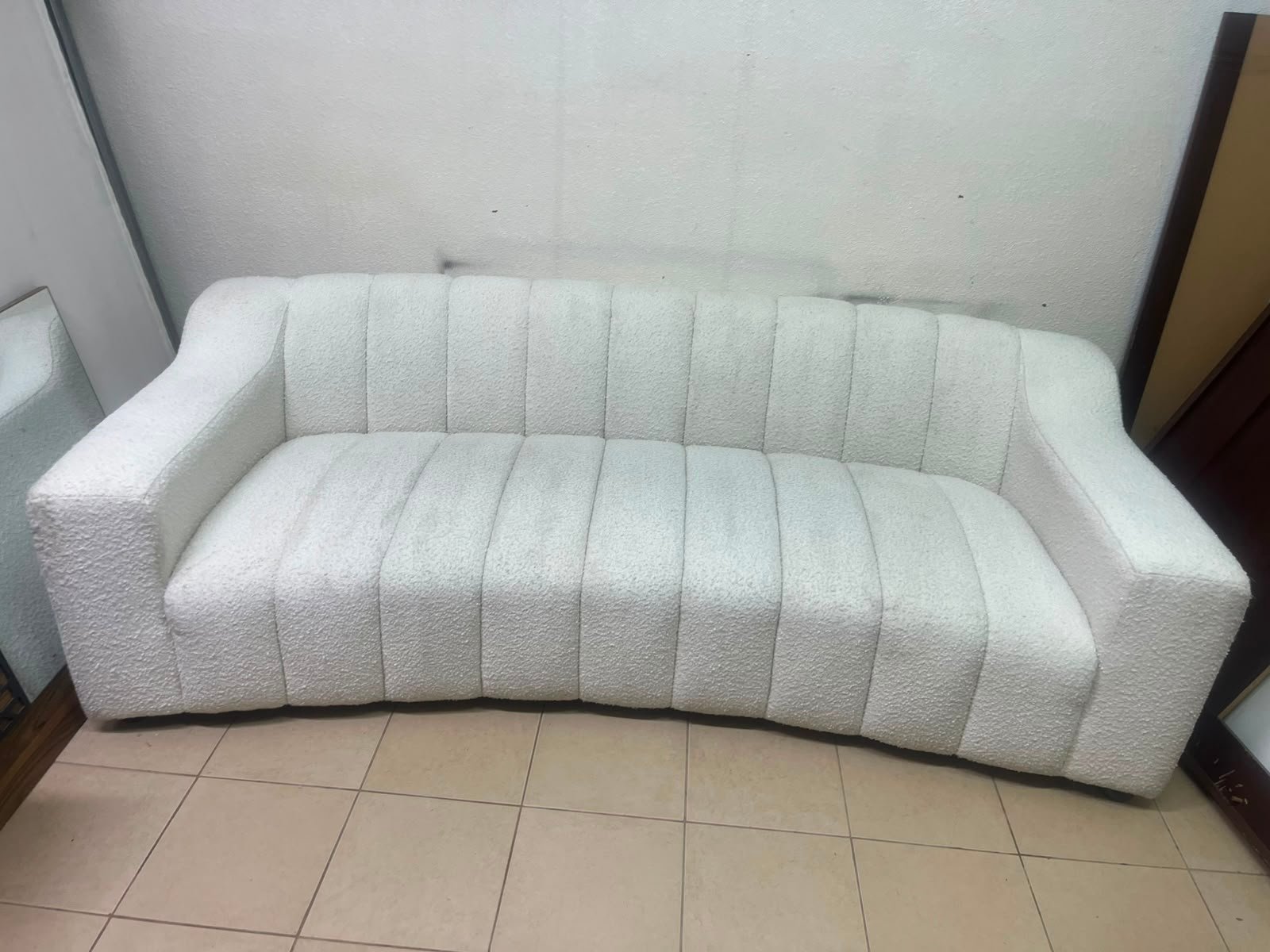 With the cream-colored Eichholtz Kelly Bouclé sofa, which features a distinctive design with signature vertical stitching and soft-touch upholstery. - Image 14