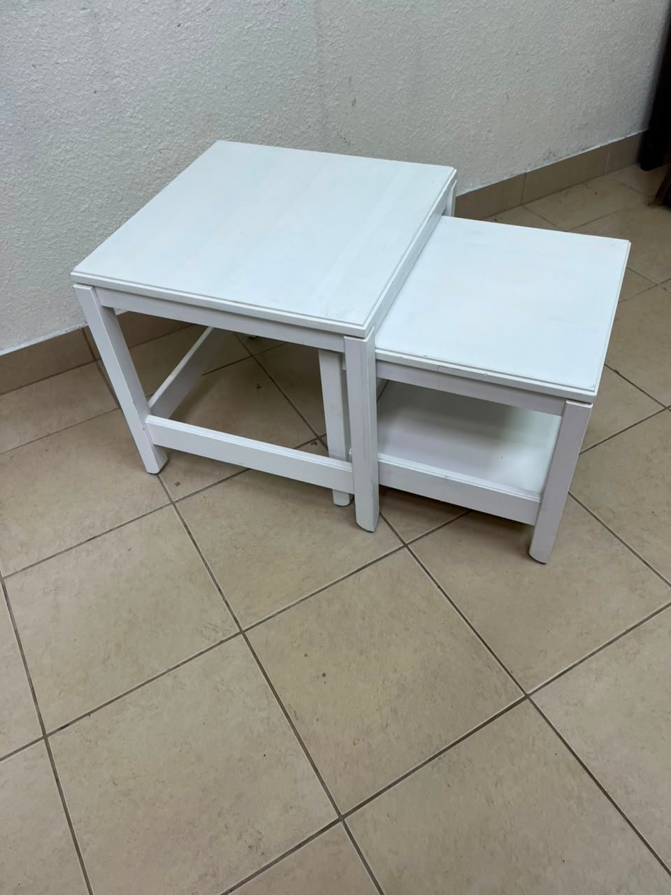 IKEA's Havista nesting table set (2-piece set in white), made of solid pine wood.