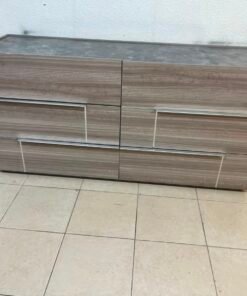 This is a Home Centre Warner 6-Drawer Dresser featuring a caramel walnut and beige finish with a marble-effect top.