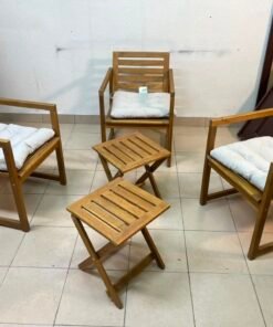 displays the IKEA NÄMMARÖ light brown stained outdoor armchairs and matching folding tables paired with KUDDARNA light gray-beige cushions. - Image 2