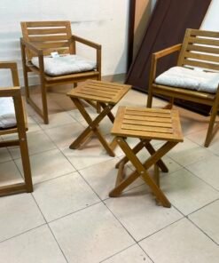 displays the IKEA NÄMMARÖ light brown stained outdoor armchairs and matching folding tables paired with KUDDARNA light gray-beige cushions. - Image 9