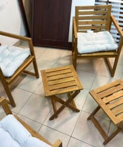 displays the IKEA NÄMMARÖ light brown stained outdoor armchairs and matching folding tables paired with KUDDARNA light gray-beige cushions. - Image 7