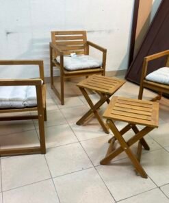 displays the IKEA NÄMMARÖ light brown stained outdoor armchairs and matching folding tables paired with KUDDARNA light gray-beige cushions. - Image 4