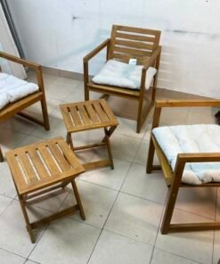 displays the IKEA NÄMMARÖ light brown stained outdoor armchairs and matching folding tables paired with KUDDARNA light gray-beige cushions.