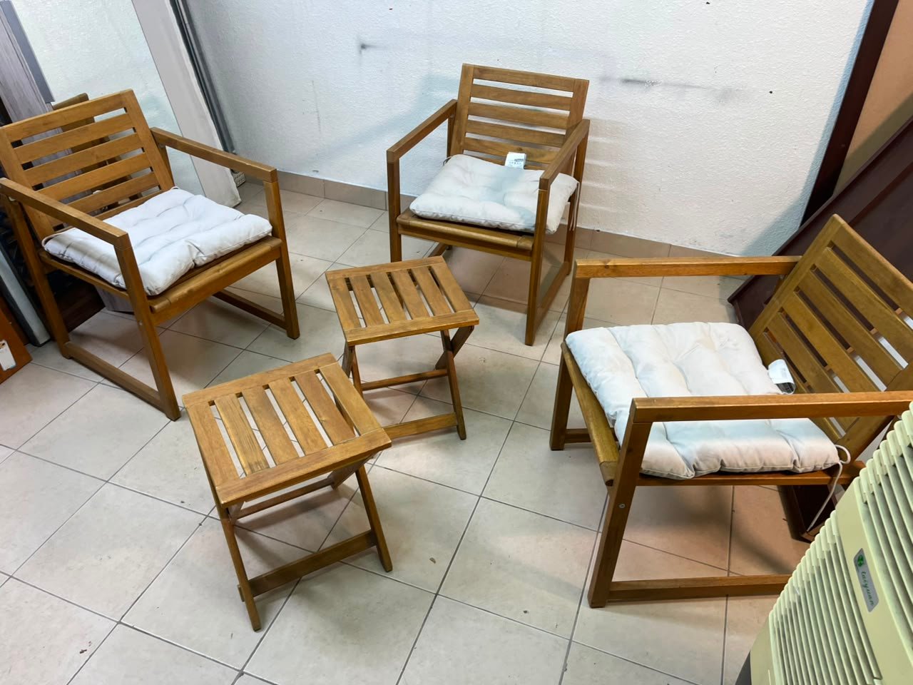 displays the IKEA NÄMMARÖ light brown stained outdoor armchairs and matching folding tables paired with KUDDARNA light gray-beige cushions.