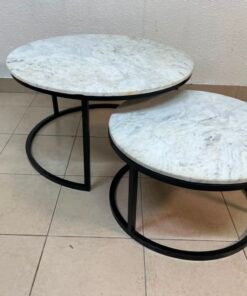 A set of nesting coffee tables (interlocking coffee tables) consisting of two pieces with a white marble top and a metal base.