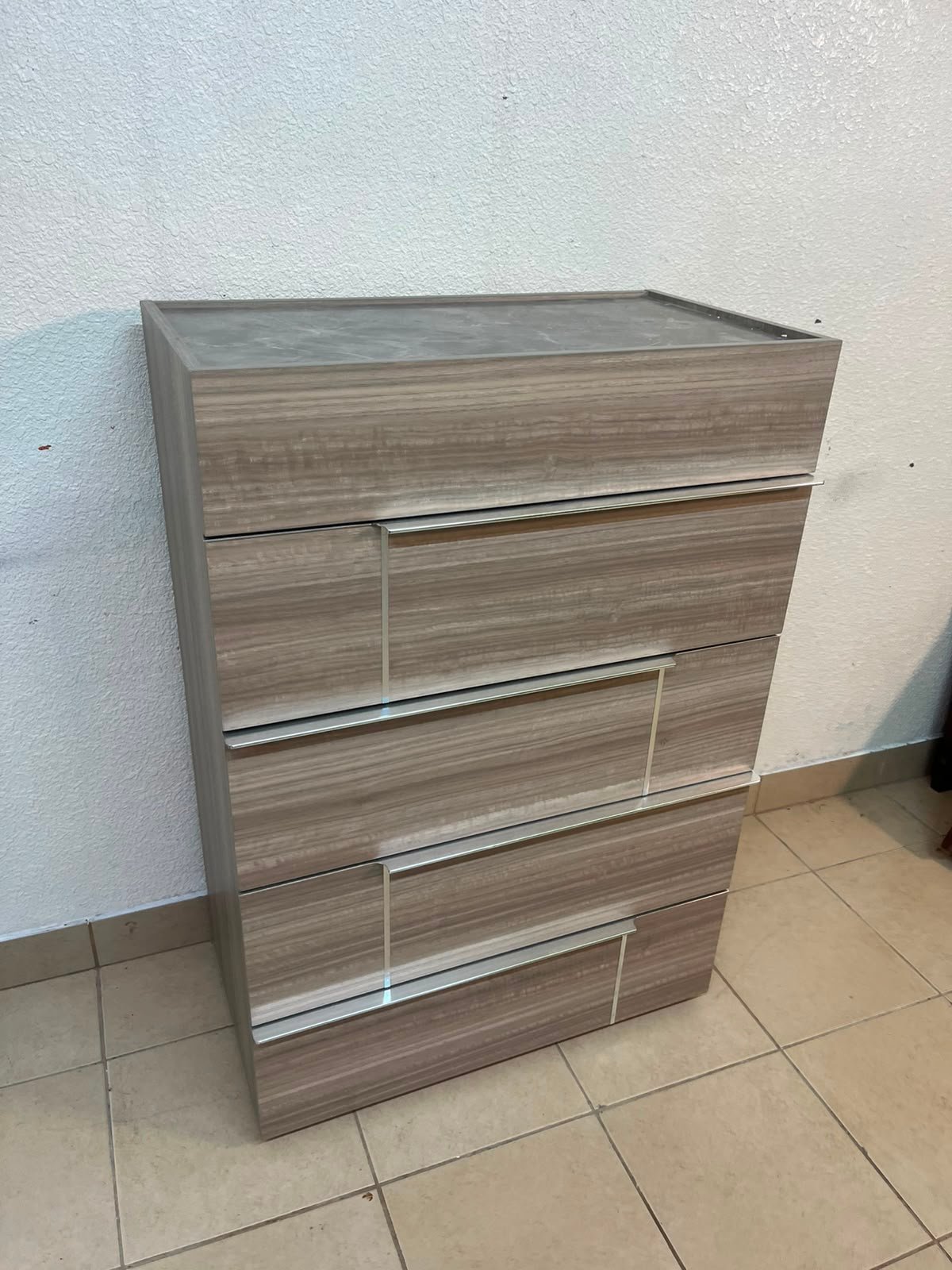 The Warner Chest of 5-Drawers from Homecentre features a beige and caramel walnut finish with distinct long metallic handles. - Image 3