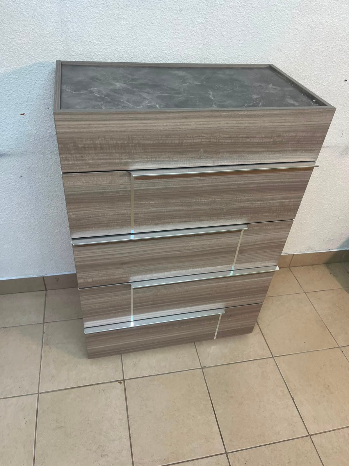 The Warner Chest of 5-Drawers from Homecentre features a beige and caramel walnut finish with distinct long metallic handles. - Image 5