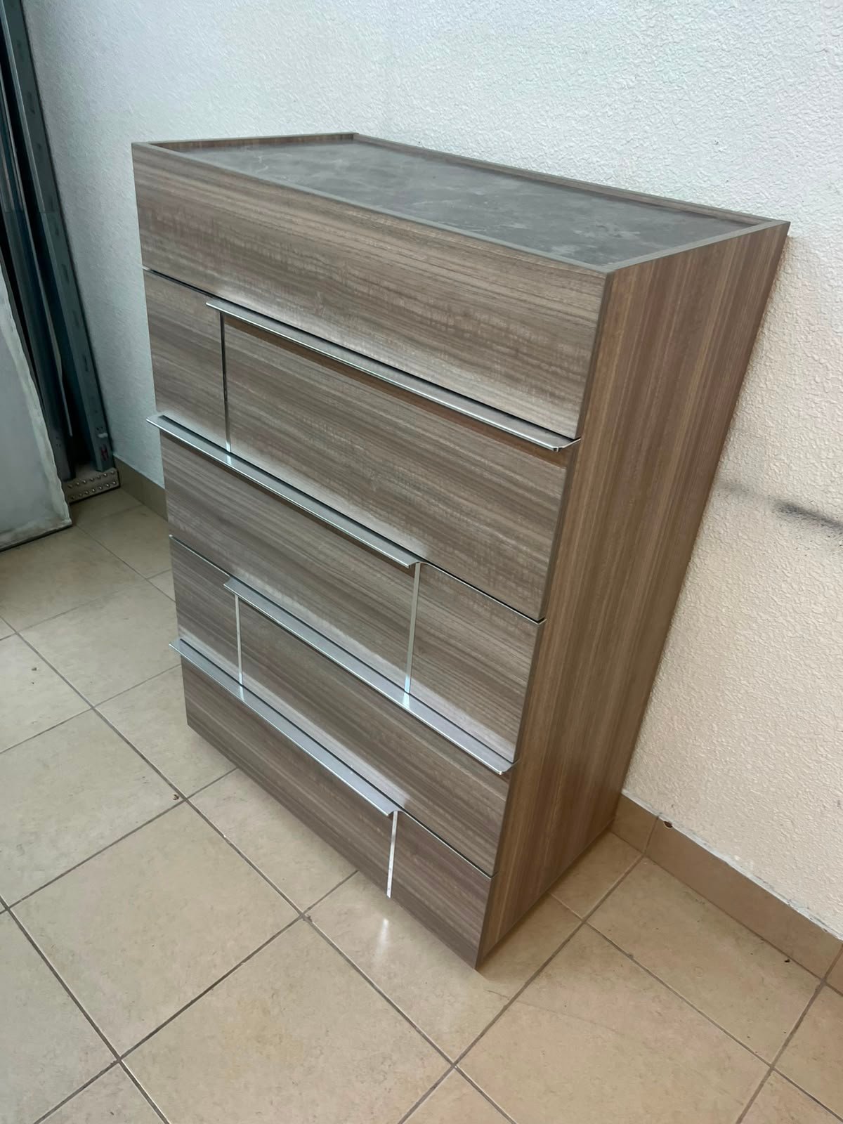 The Warner Chest of 5-Drawers from Homecentre features a beige and caramel walnut finish with distinct long metallic handles. - Image 6