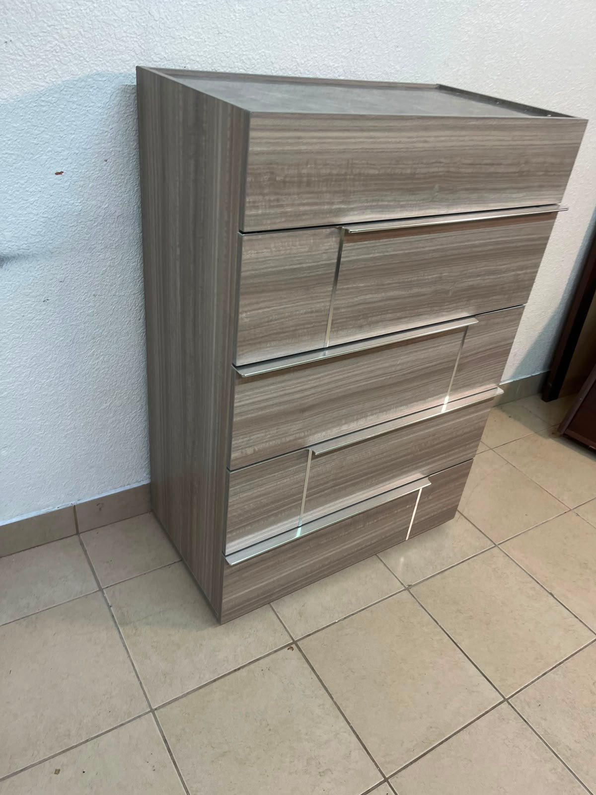 The Warner Chest of 5-Drawers from Homecentre features a beige and caramel walnut finish with distinct long metallic handles. - Image 4