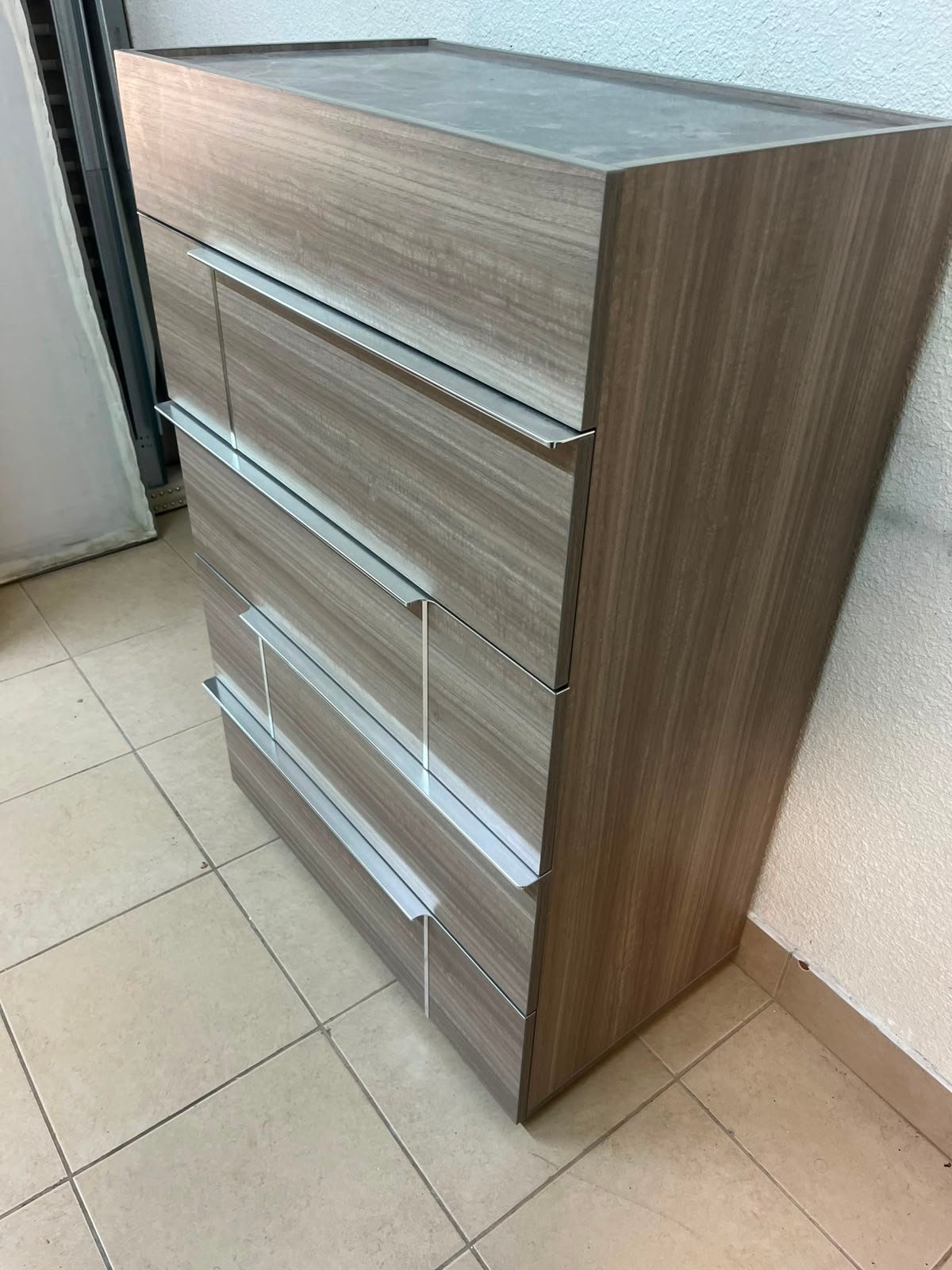 The Warner Chest of 5-Drawers from Homecentre features a beige and caramel walnut finish with distinct long metallic handles. - Image 14