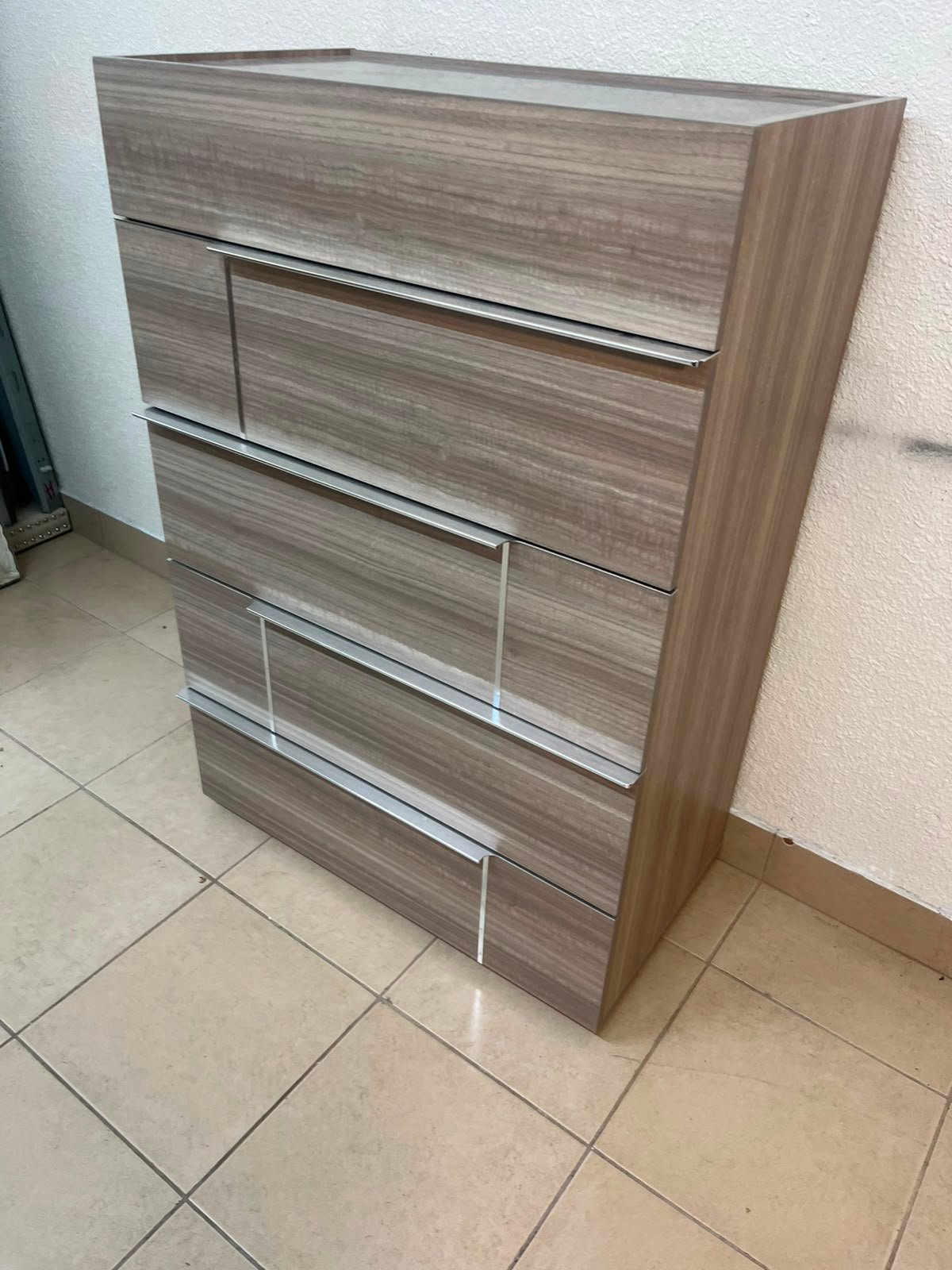 The Warner Chest of 5-Drawers from Homecentre features a beige and caramel walnut finish with distinct long metallic handles. - Image 12