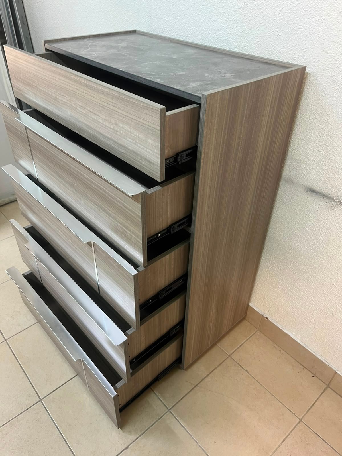The Warner Chest of 5-Drawers from Homecentre features a beige and caramel walnut finish with distinct long metallic handles. - Image 13