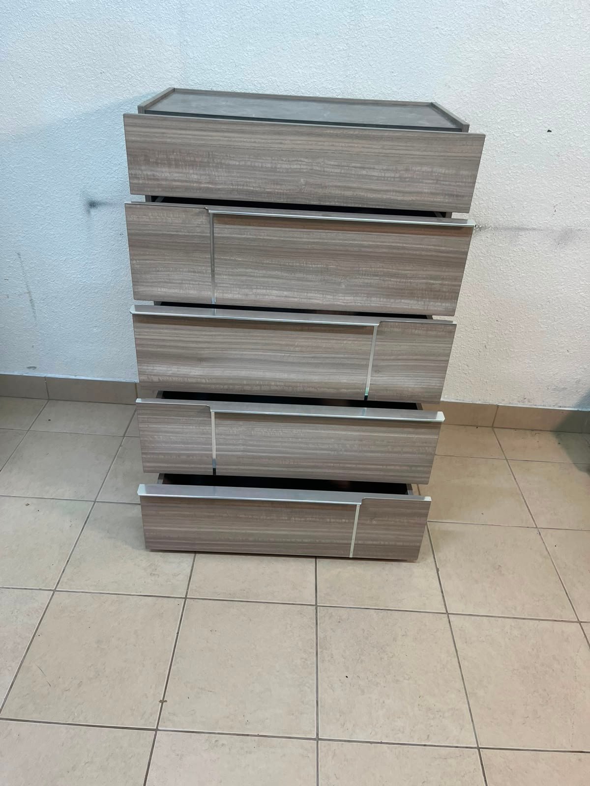 The Warner Chest of 5-Drawers from Homecentre features a beige and caramel walnut finish with distinct long metallic handles. - Image 8