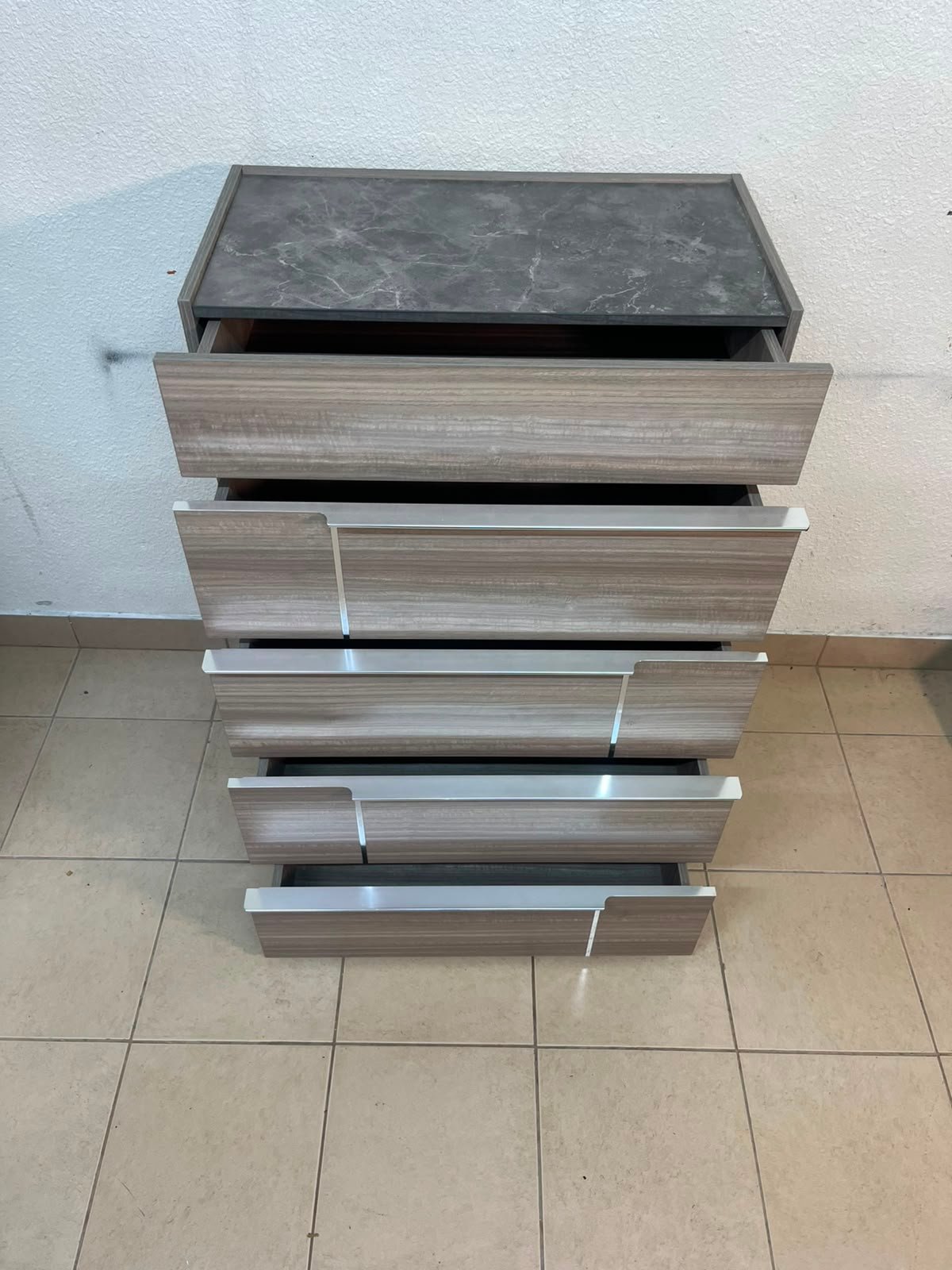 The Warner Chest of 5-Drawers from Homecentre features a beige and caramel walnut finish with distinct long metallic handles. - Image 7