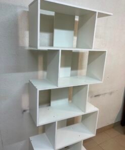 This white 5-tier geometric S-shaped bookshelf functions as an open display rack or room divider.