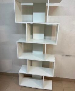 This white 5-tier geometric S-shaped bookshelf functions as an open display rack or room divider. - Image 8