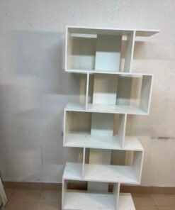 This white 5-tier geometric S-shaped bookshelf functions as an open display rack or room divider. - Image 10