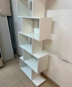 This white 5-tier geometric S-shaped bookshelf functions as an open display rack or room divider. - Image 7