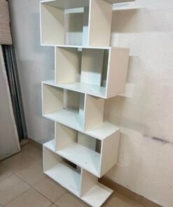 This white 5-tier geometric S-shaped bookshelf functions as an open display rack or room divider. - Image 6
