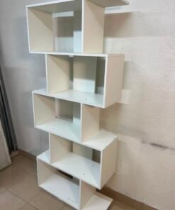 This white 5-tier geometric S-shaped bookshelf functions as an open display rack or room divider. - Image 9